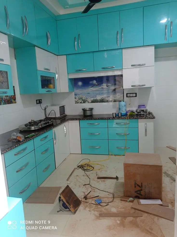 Modern acrylic L-shaped modular kitchen installation in Patna by Shivani Interior CNC Works